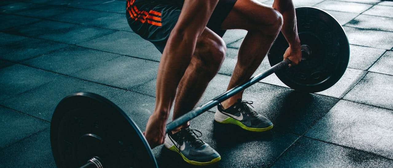 Image of a man lifting weights as part of his fitness routine